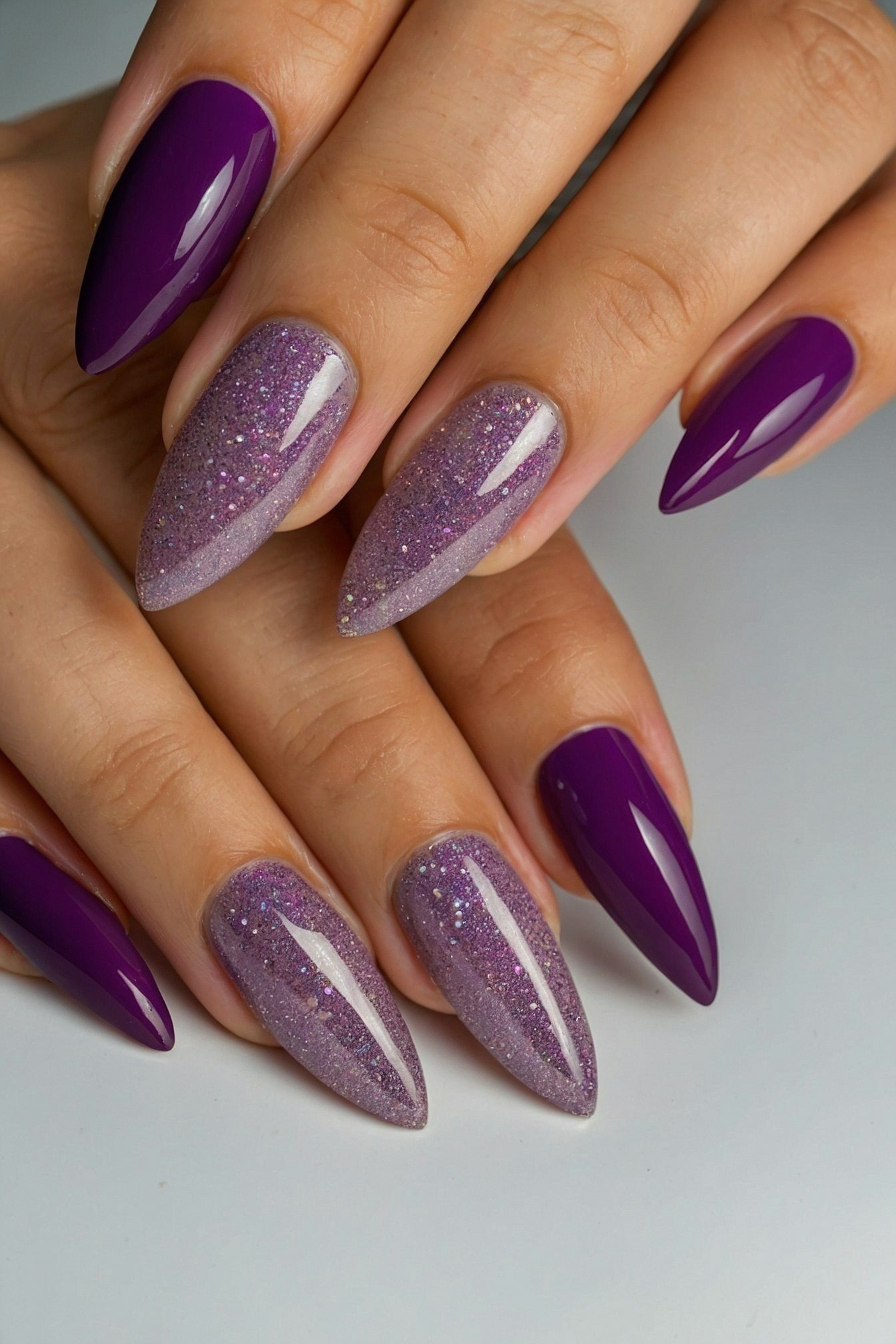 Deep Purple Almond Nails with Glitter Accents