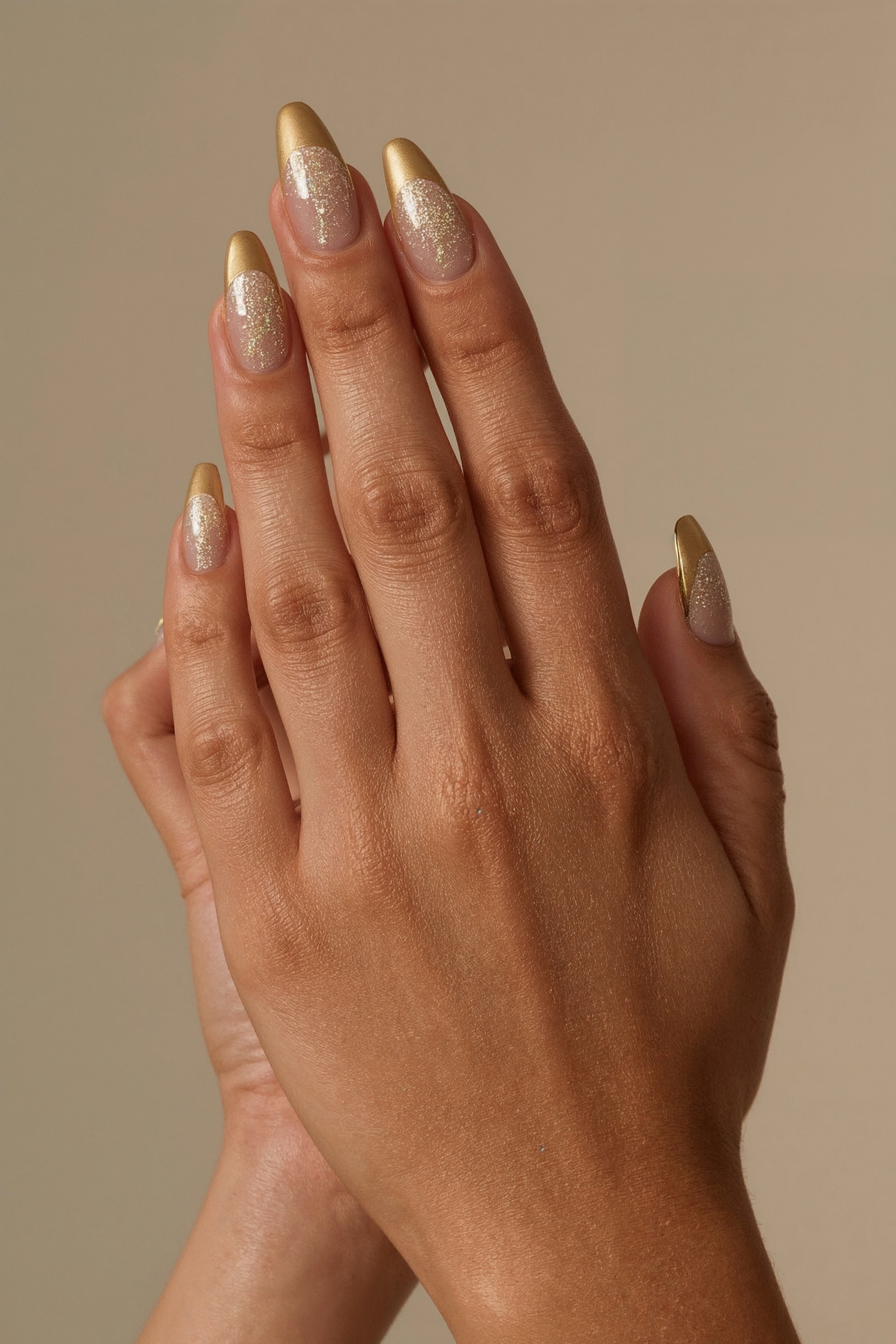 Almond-shaped nails with gilded tips