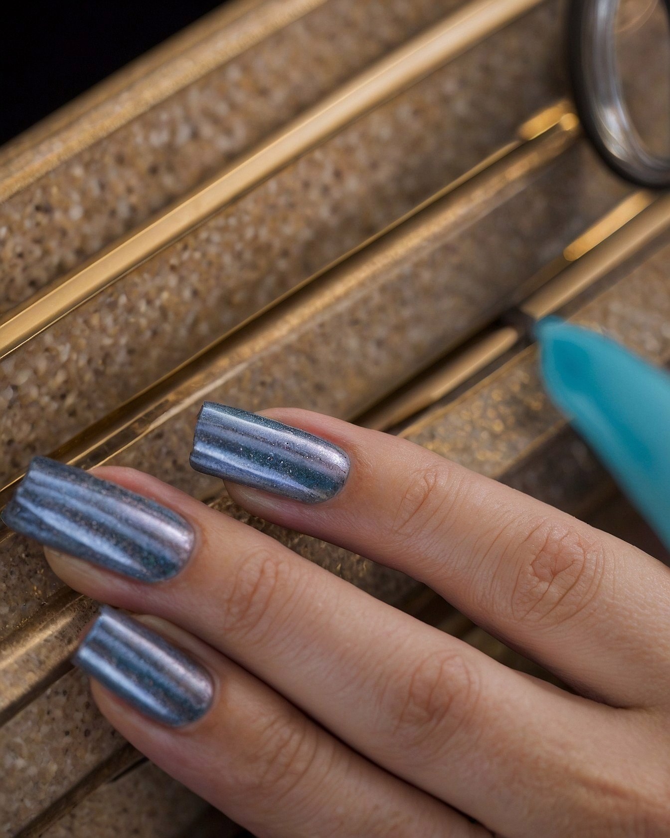 Close-up of Metallic Nails on Textured Surface