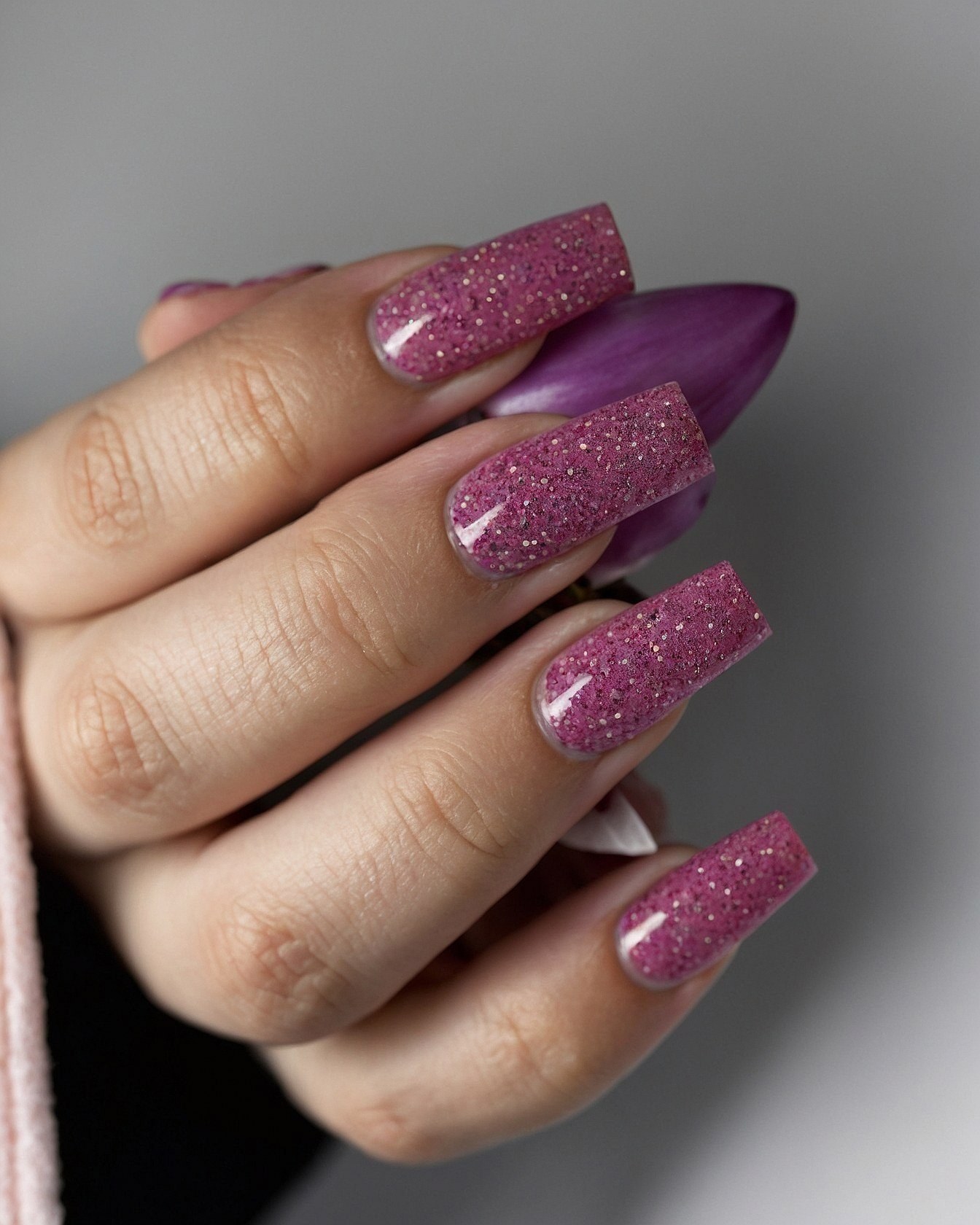 What makes these glittery pink nails so captivating?