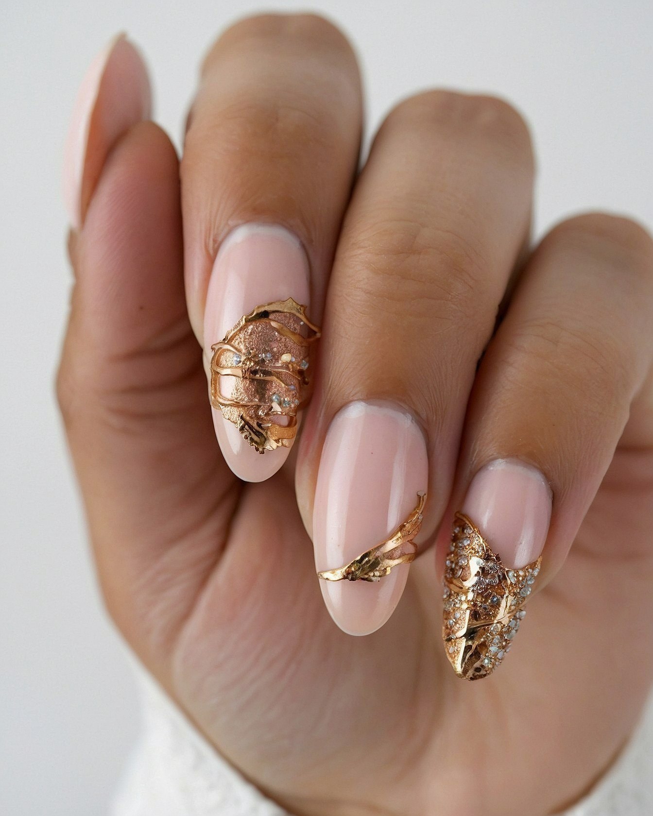 Close-Up of Textured Rose Gold Nail Embellishments