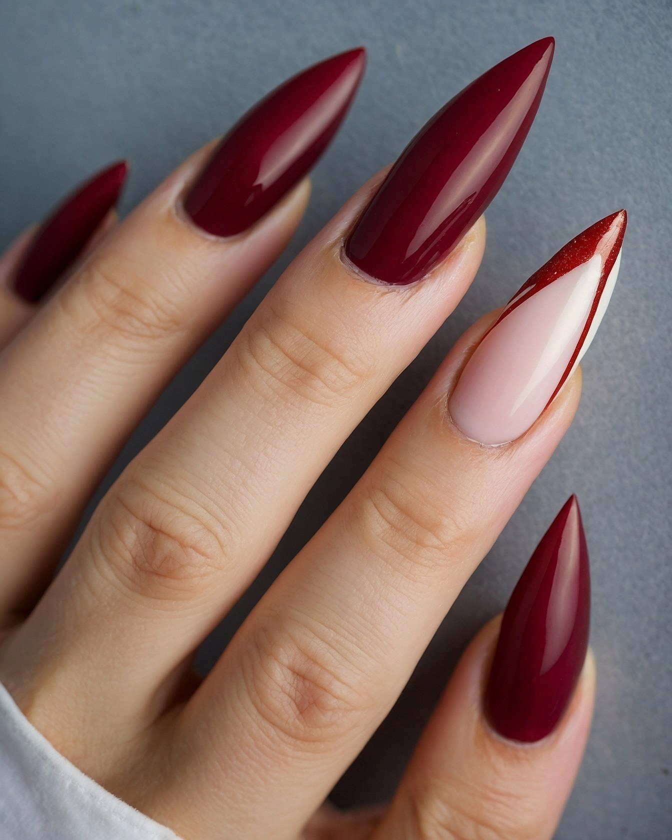 Close-up of a Hand with Burgundy Stiletto Nails