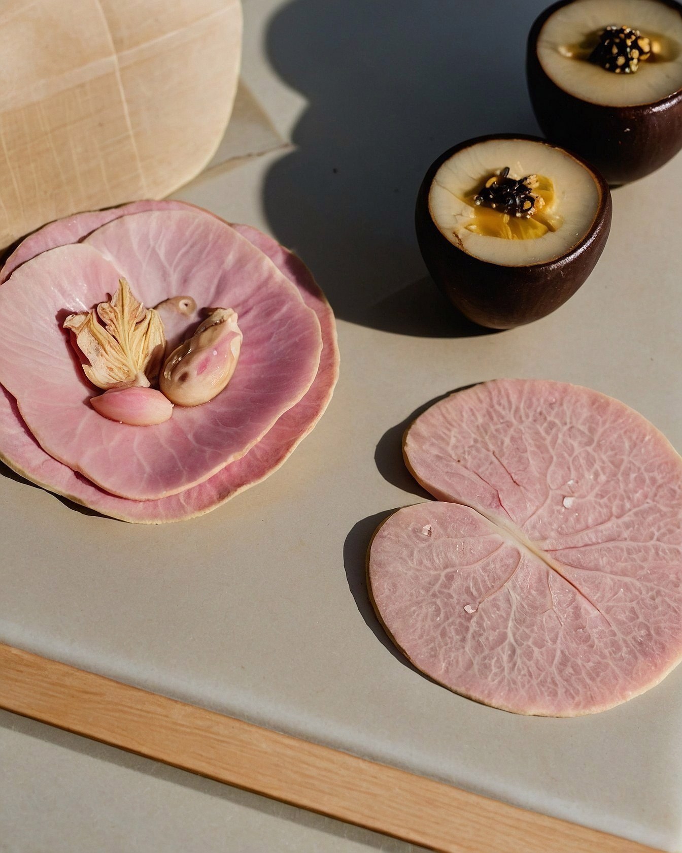 Delicate layered pink garnishes on a muted surface