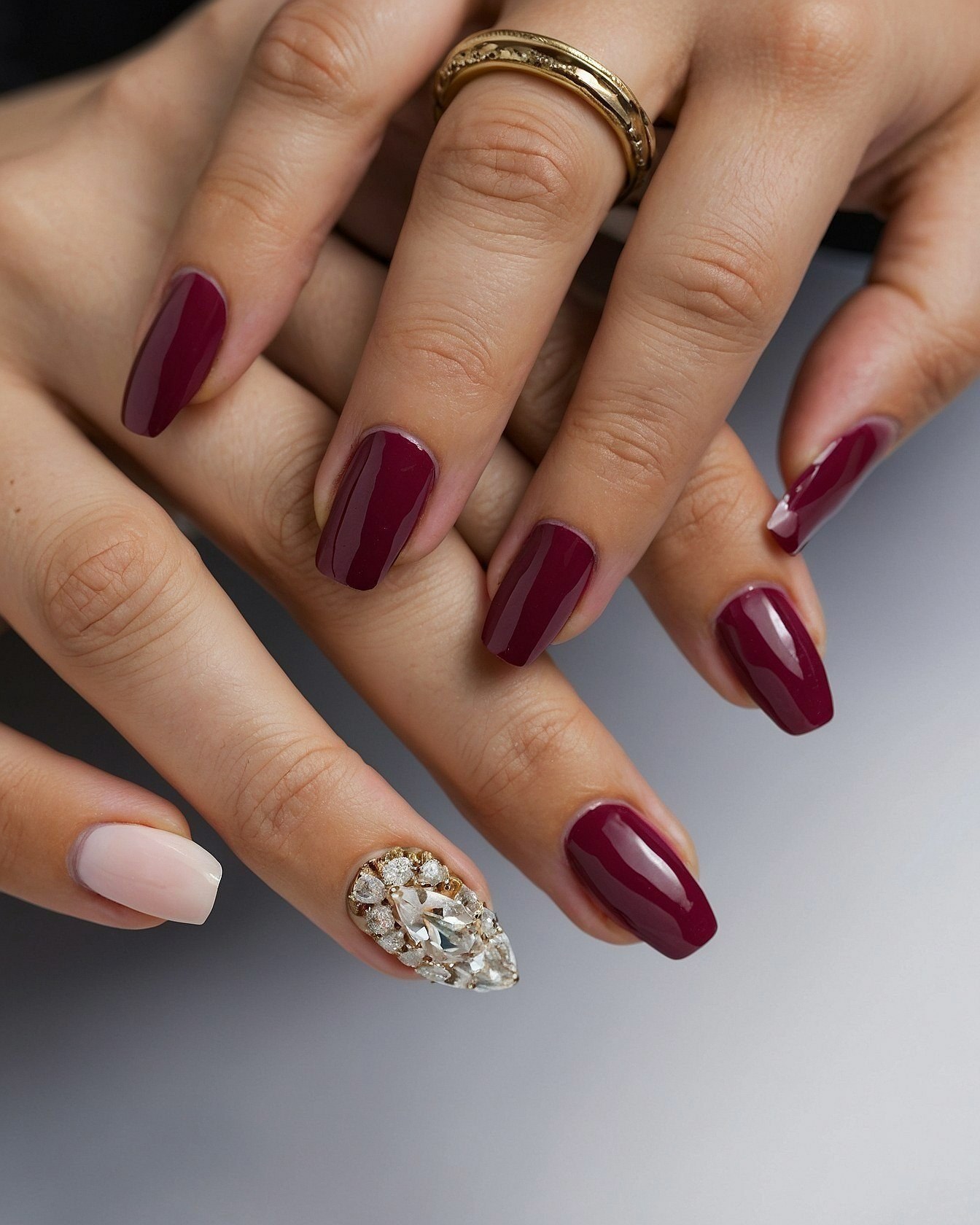 Deep Berry Coffin Nails with a Crystal Accent