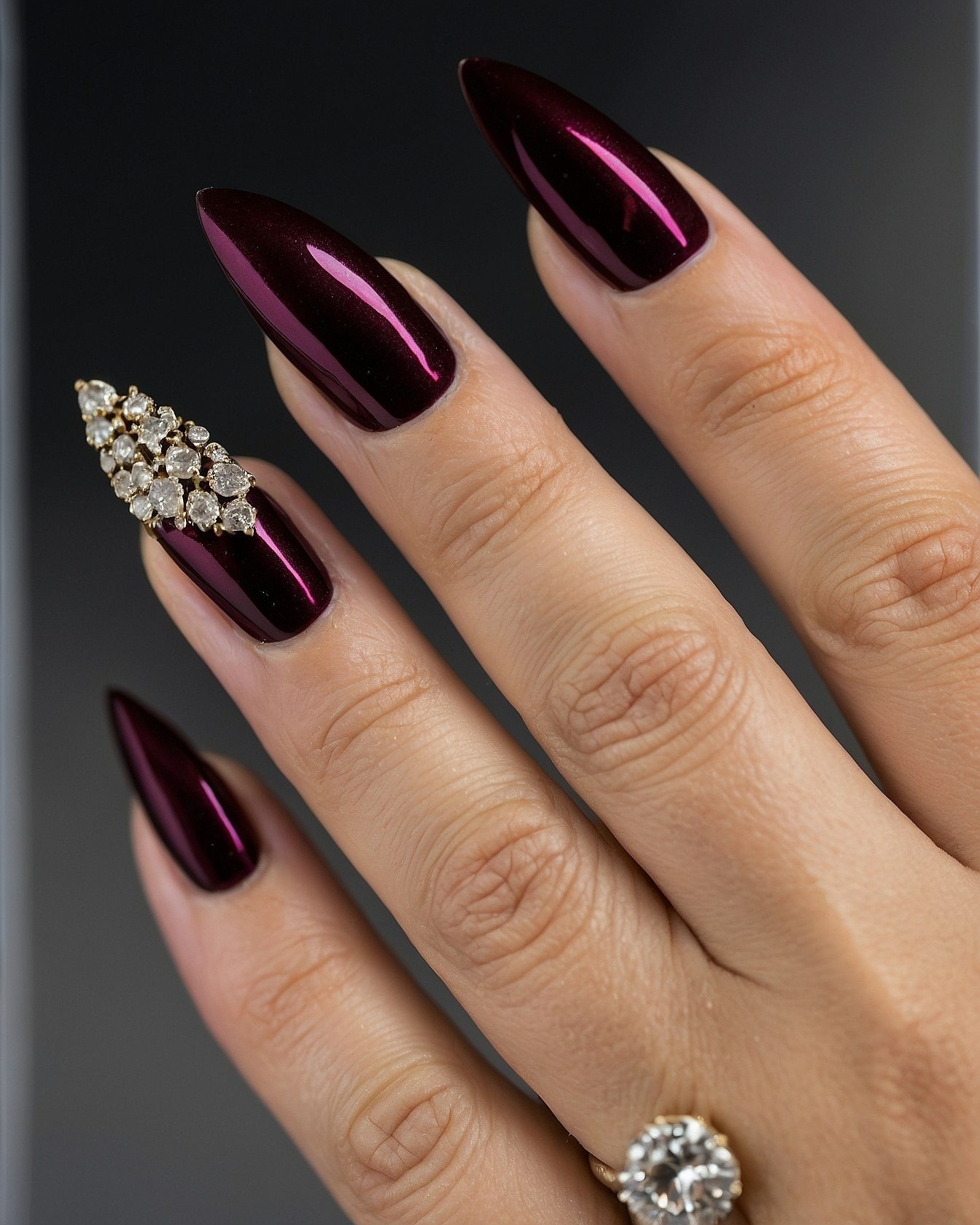 Deep Cherry Red Stiletto Nails with Crystal Embellishments