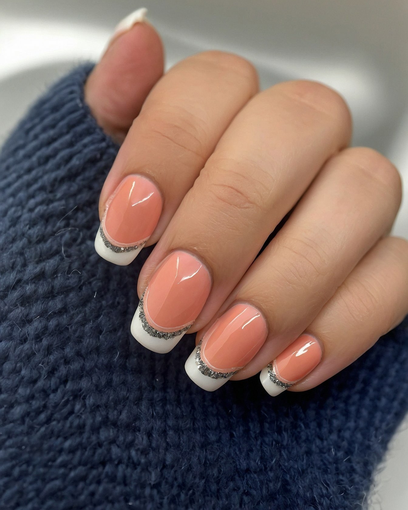 Close-up on Oval Nails with Silver Glitter Accents