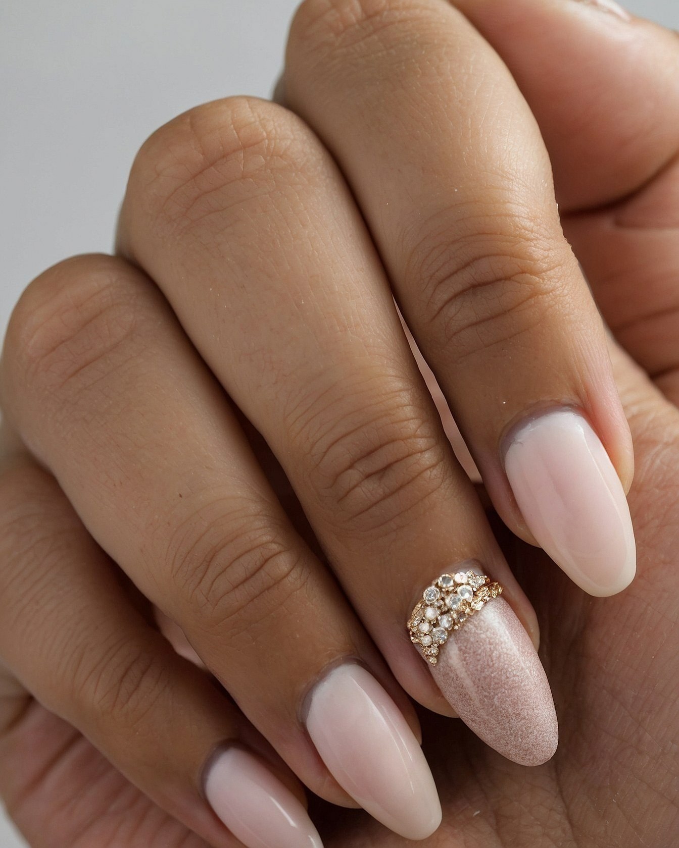 Subtle Glamour: Soft Nude Nails with a Jeweled Accent