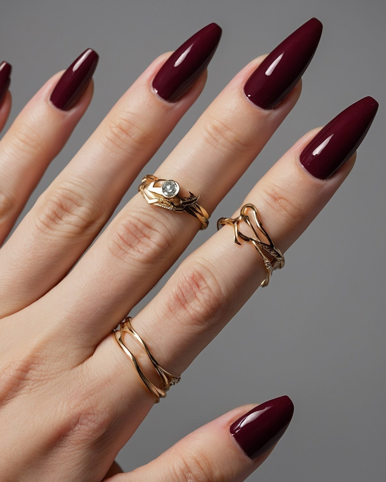 Glossy Dark Cherry Coffin Nails with Gold Rings