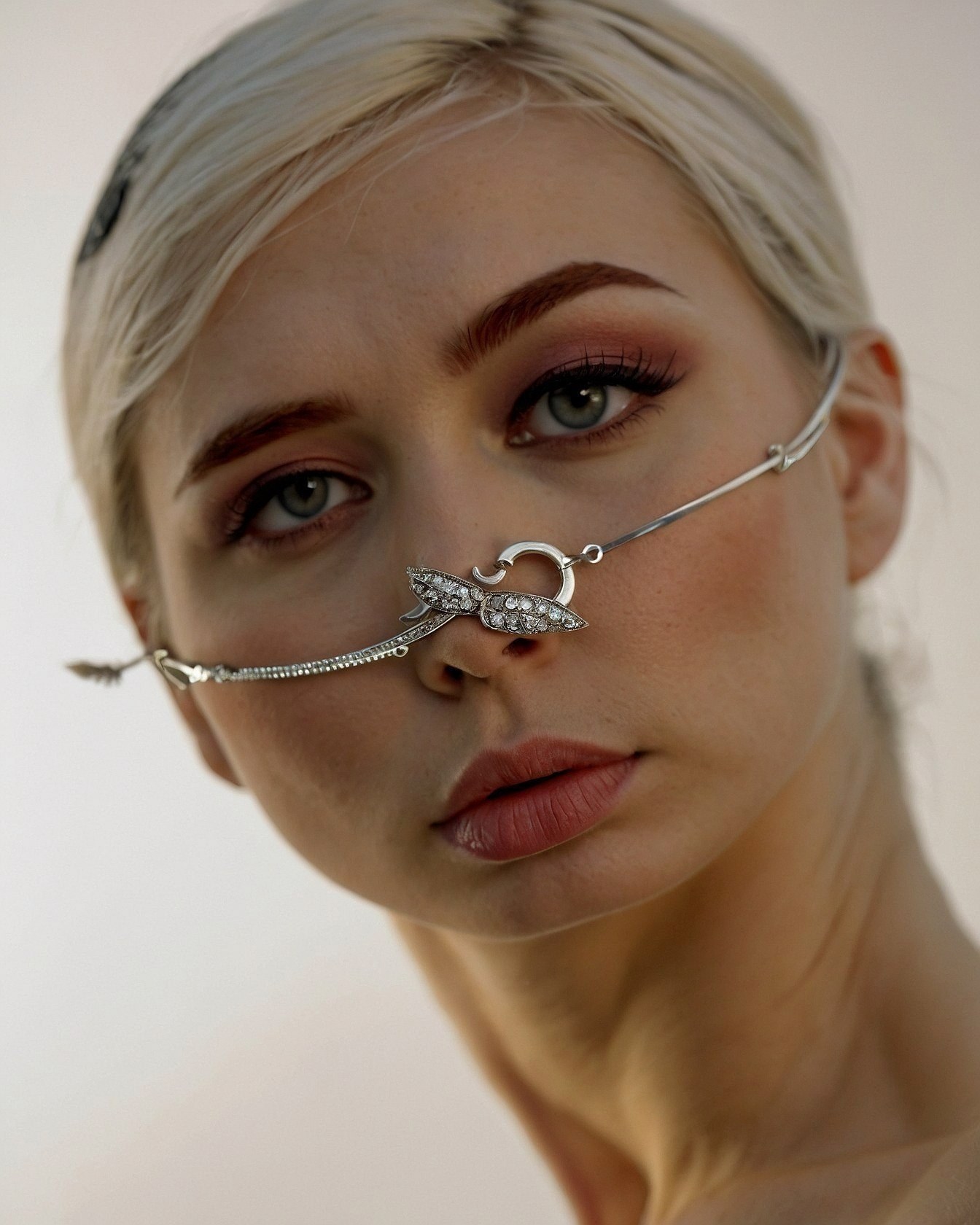 Intricate Silver Chains Juxtaposed with Soft Features