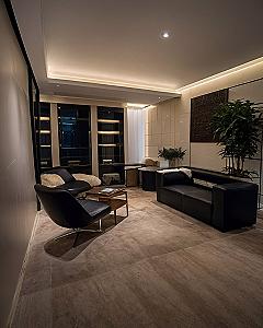 Adding Sleek Black Leather Seating to a Dark Theme Room