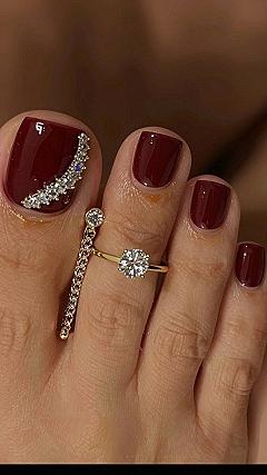 Adding Rhinestone Accents to Dark Red Toenails