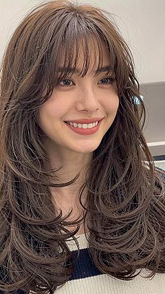Layered Blowout with Soft Bangs for Long Hair