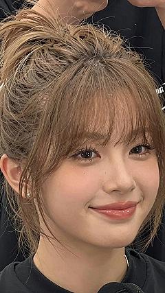 High Topknots Paired With Textured Bangs