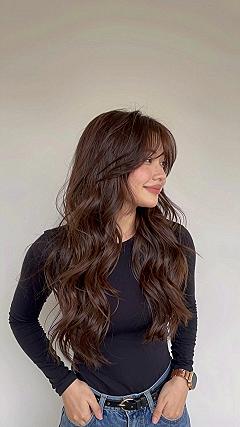 Why Soft Layers and Bangs Elevate Cherry Cola Brunette Hair