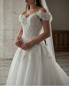 Off-the-shoulder sleeves meet intricate lace detailing