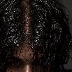 Wet Look Waves: Slicked Haircut with a Modern Middle Part