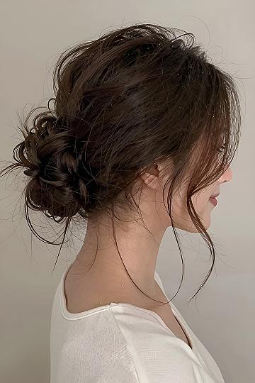 Low Messy Bun With Loose Front Pieces