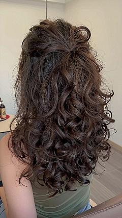 Half-Up Curly Hair Styled With A Hair Bow