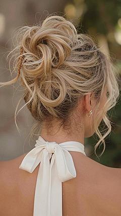 Messy High Chignon with Loose Tendrils for Weddings