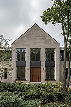 2025 Home Exterior Trends: Stone & Black Windows for Modern Style