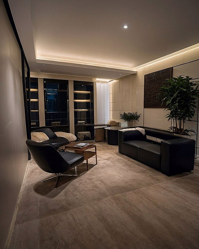 Adding Sleek Black Leather Seating to a Dark Theme Room