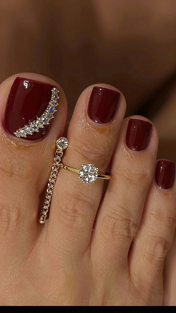 Adding Rhinestone Accents to Dark Red Toenails
