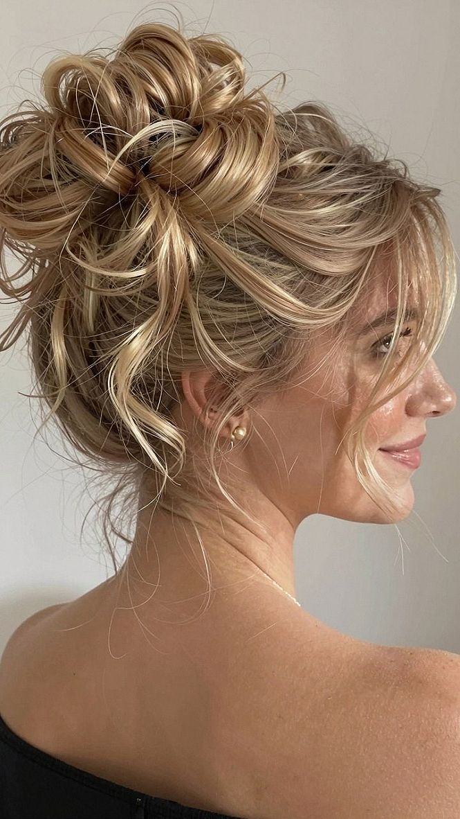 Messy High Bun Wedding Updo With Loose Tendrils