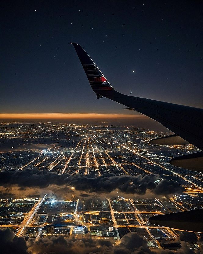 Starlight glinting off the polished wingtip above nocturnal city grids