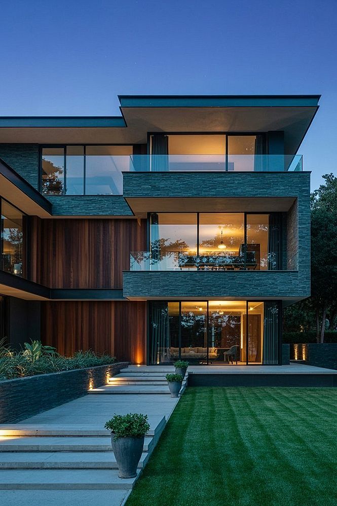 Modern Stone House Exterior: Twilight Glow and Glass Elegance
