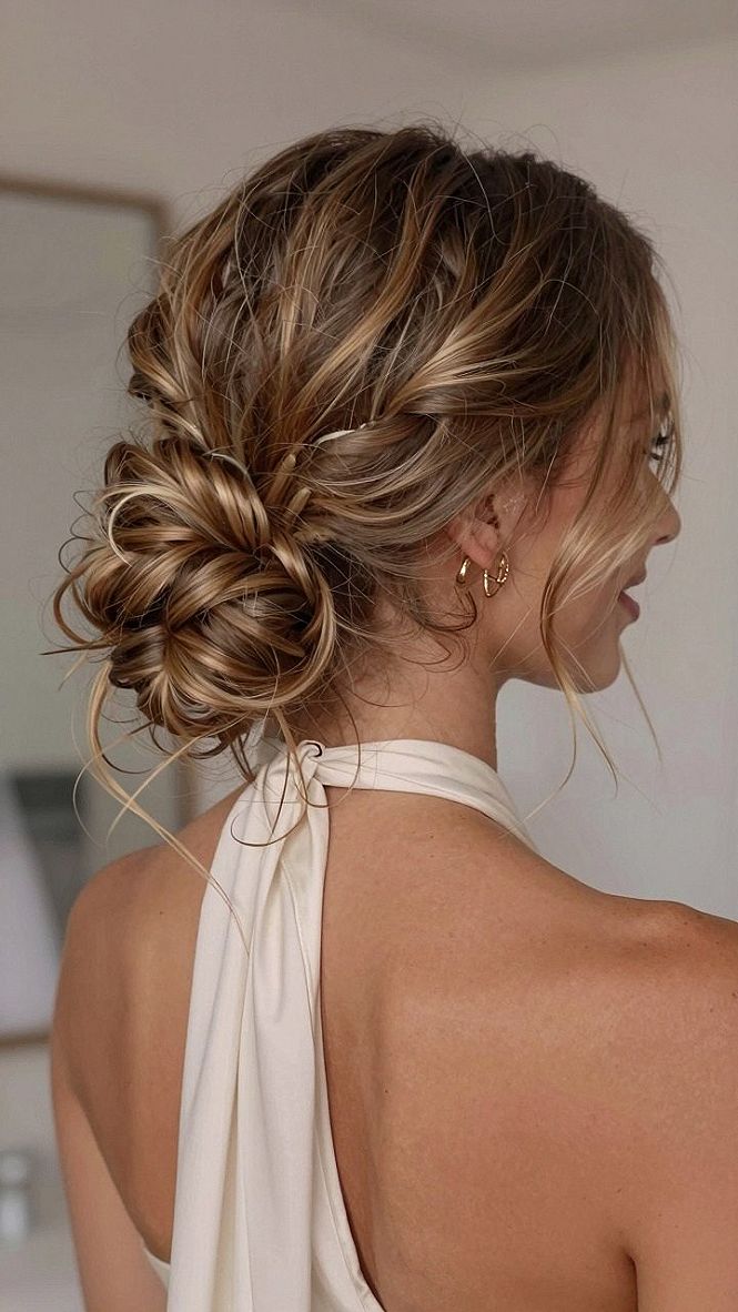 Messy Braided Updo With Loose Wavy Tendrils