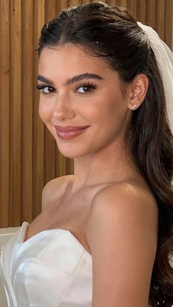 Securing A Half Up Wedding Hairstyle With A Low Veil Placement