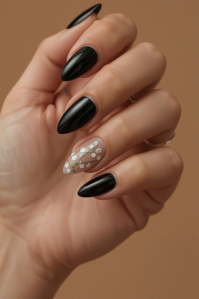 Chic Black Almond Nails with Delicate White Floral Accents
