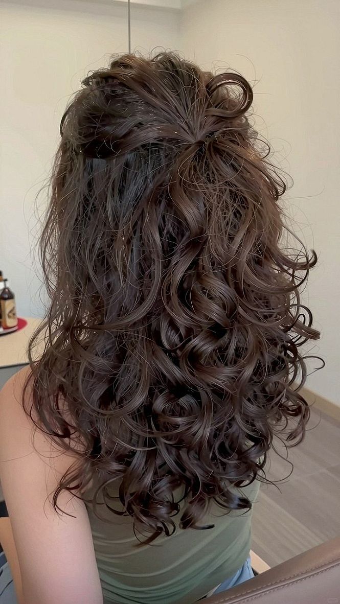 Half-Up Curly Hair Styled With A Hair Bow