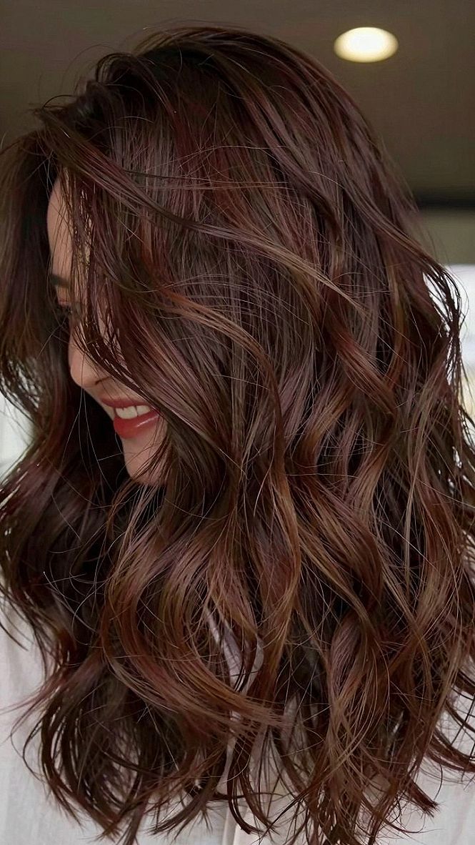 Maintaining Glossy Auburn Waves With Fine Caramel Highlights