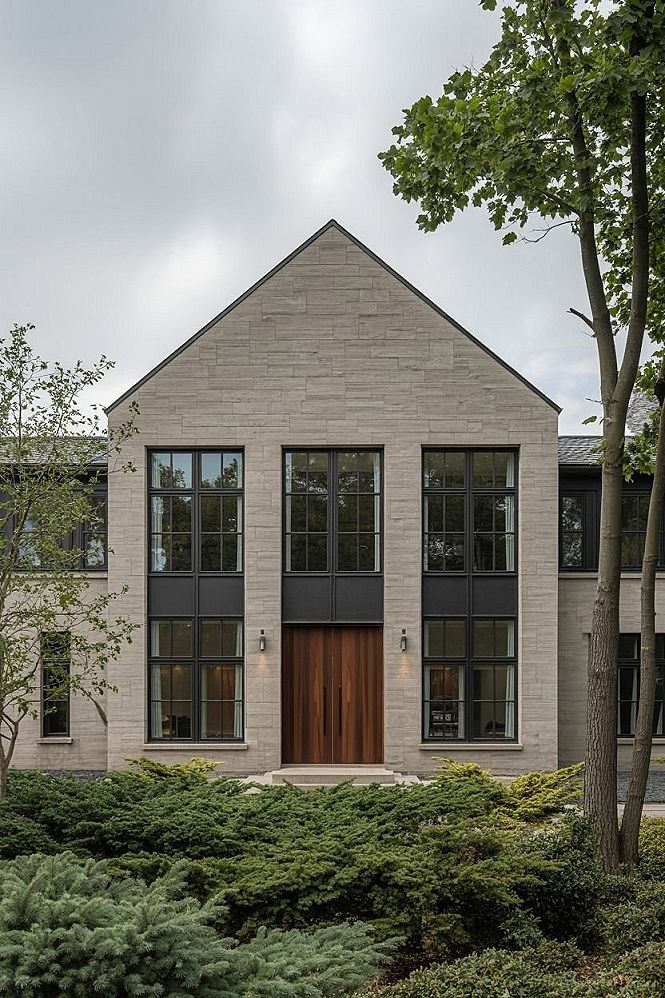 2025 Home Exterior Trends: Stone & Black Windows for Modern Style