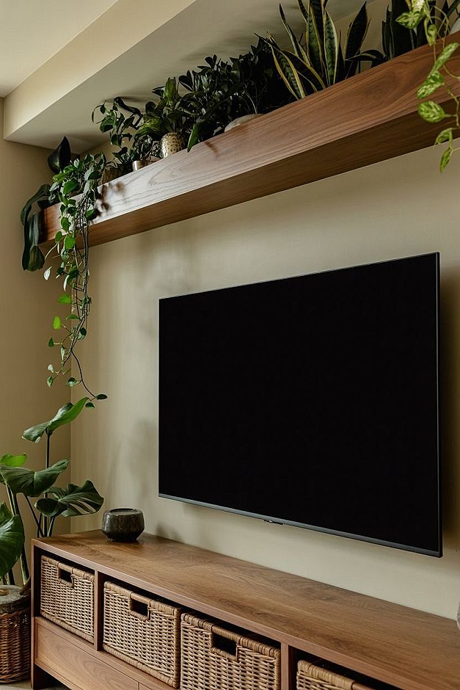 Cozy Living Room with Floating Shelves & Lush Houseplants