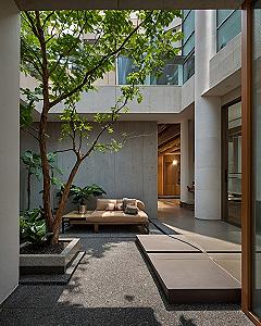 Warm beige and concrete tones in an open-air atrium