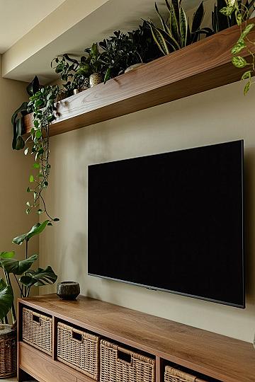Cozy Living Room with Floating Shelves & Lush Houseplants