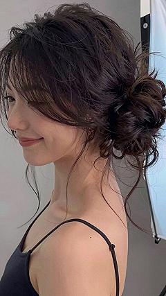 Low Textured Bun With Soft Bangs For Easy Reception Wear
