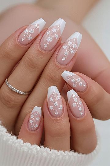 Chic French Tip Almond Nails with Delicate Floral Accents