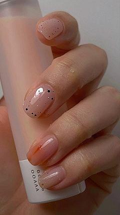 Pairing Deep Orange Nails With Subtle Speckled Top Coats