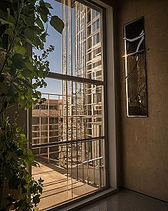 Hanging Single Statement Frames Beside Large Windows