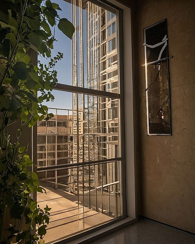 Hanging Single Statement Frames Beside Large Windows