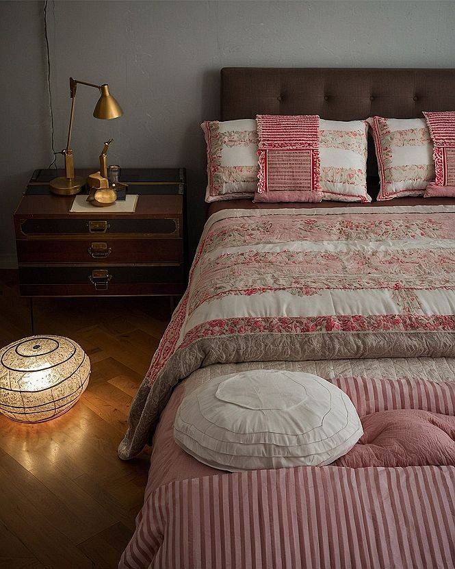 Styling A Joyful Bedroom With Striped Bedding And Warm Light