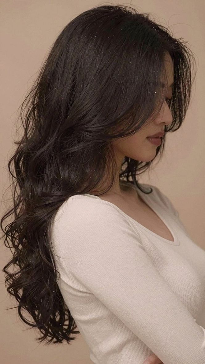 Maintaining Long Wavy Hair With Voluminous Curtain Bangs