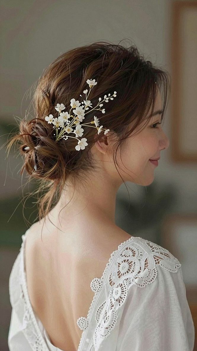 Securing White Blossom Hair Pins in a Low Messy Bun