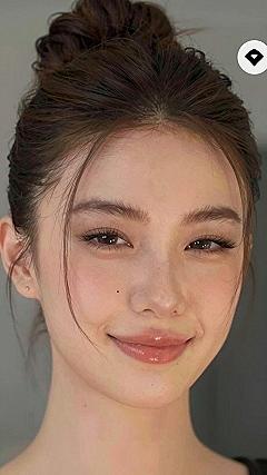 Mastering the High Top Knot Bun with Loose Strands