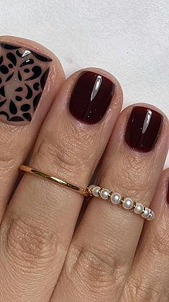 Pairing Burgundy Gel Pedicures with Black Swirl Accent Nails