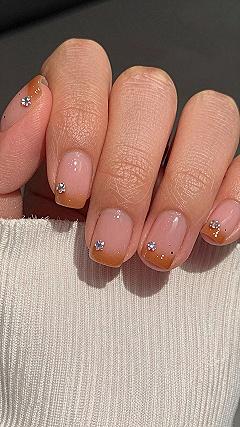 Applying Tiny Gemstones to Warm Orange Halloween Pedicures