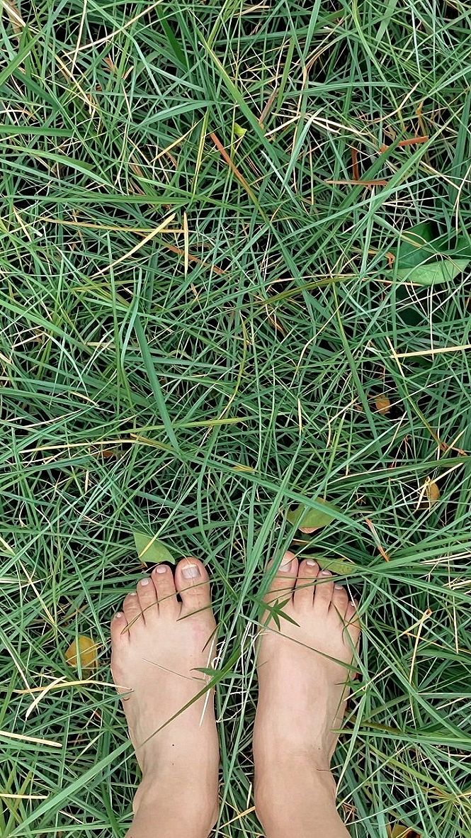 Stepping Barefoot Onto Lush Lawn Grass